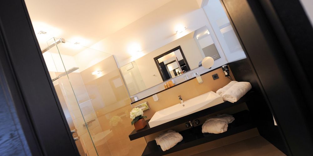 Penthouse designer bathroom with modern fixtures at Vier Jahreszeiten hotel