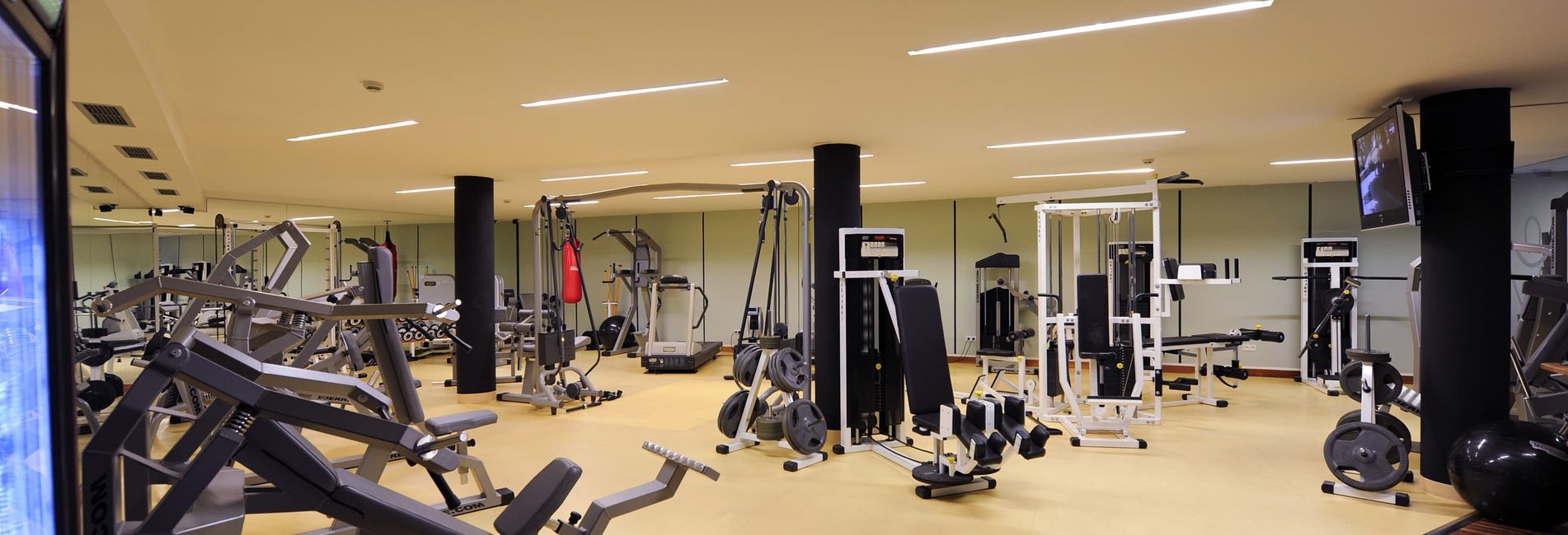 Modern fitness center at Hotel Vier Jahreszeiten in South Tyrol with gym equipment Modern fitness center at Hotel Vier Jahreszeiten in South Tyrol with gym equipment