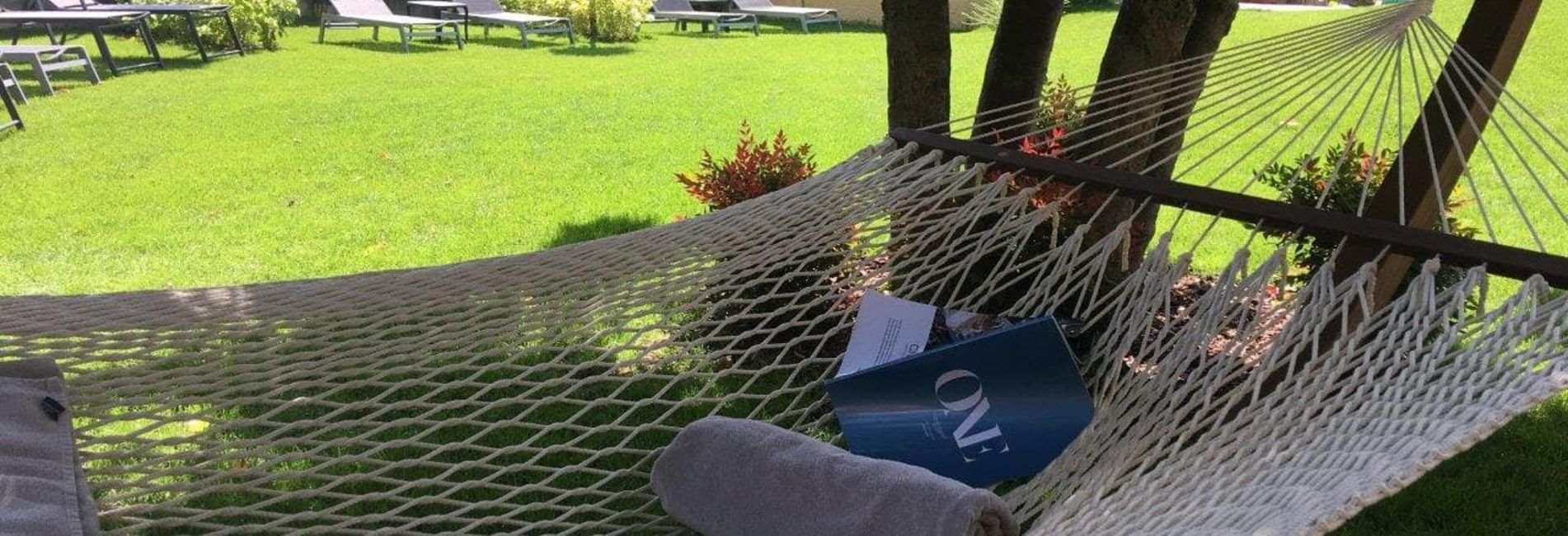 Relaxation in hammock on garden lawn at Hotel Vier Jahreszeiten South Tyrol Relaxation in hammock on garden lawn at Hotel Vier Jahreszeiten South Tyrol