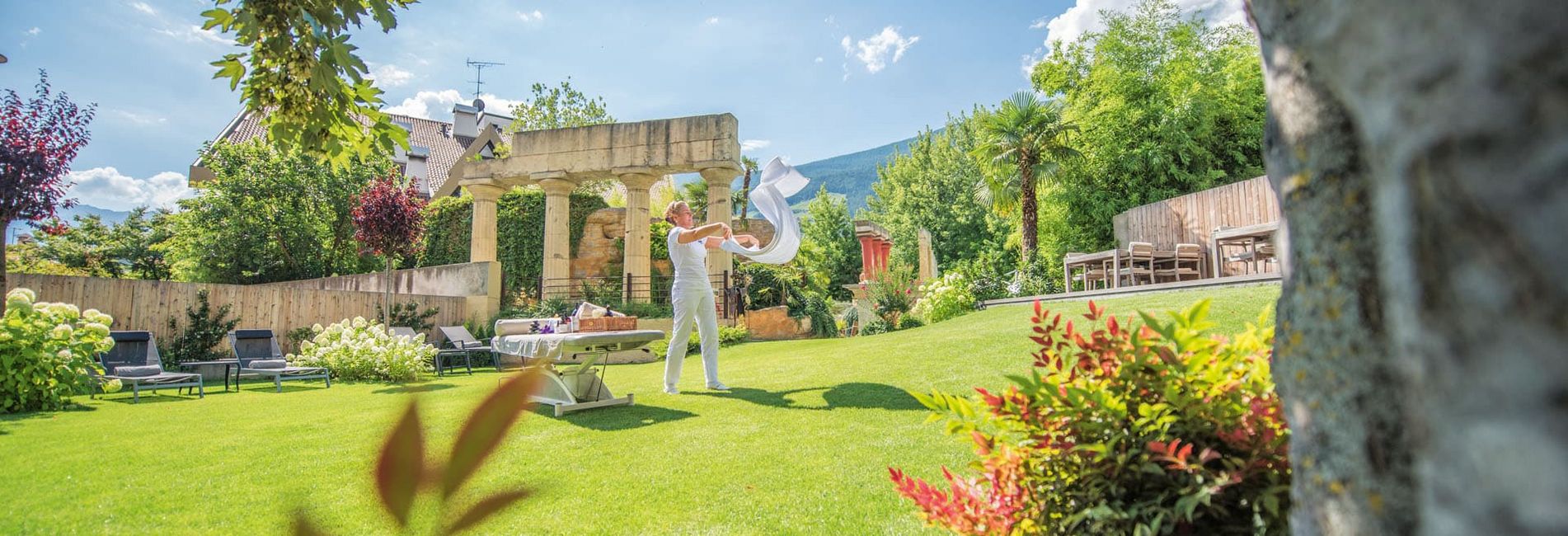 Garden lawn with sun loungers and massage area at Hotel Vier Jahreszeiten in South Tyrol Garden lawn with sun loungers and massage area at Hotel Vier Jahreszeiten in South Tyrol