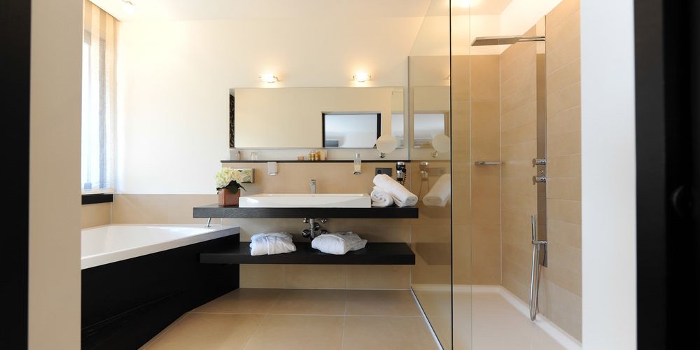 Luxurious penthouse designer suite bathroom with modern amenities at Vier Jahreszeiten hotel