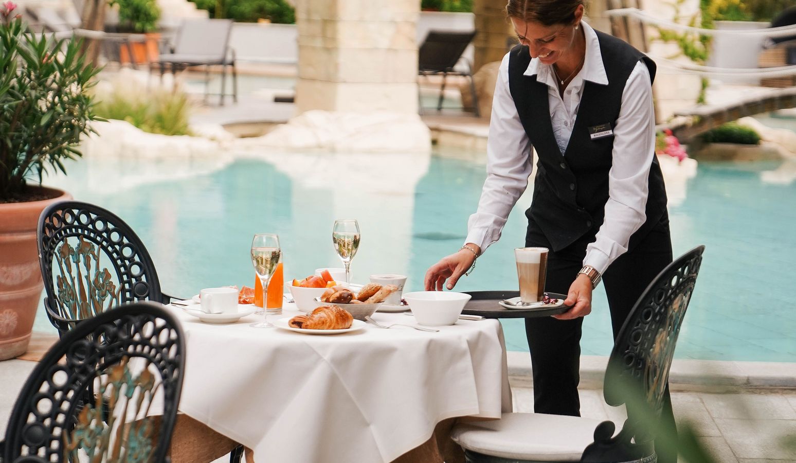 Hotel breakfast buffet with fresh pastries, fruit, and coffee at Vier Jahreszeiten Hotel Hotel breakfast buffet with fresh pastries, fruit, and coffee at Vier Jahreszeiten Hotel