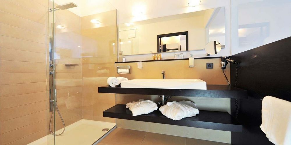 Luxurious penthouse designer suite bathroom with modern alpine decor at Vier Jahreszeiten hotel