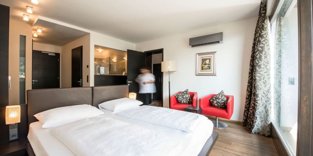 Penthouse designer suite bedroom with mountain view at Vier Jahreszeiten hotel in South Tyrol
