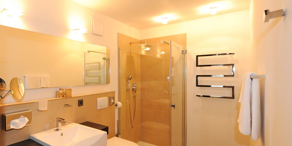 Luxury penthouse designer suite bathroom at Vier Jahreszeiten hotel with modern amenities