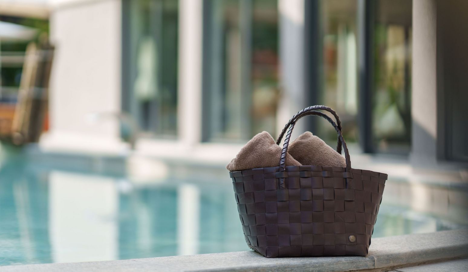 Panoramic view of luxury Vier Jahreszeiten Hotel in South Tyrol with outdoor pool and mountain backdrop Panoramic view of luxury Vier Jahreszeiten Hotel in South Tyrol with outdoor pool and mountain backdrop